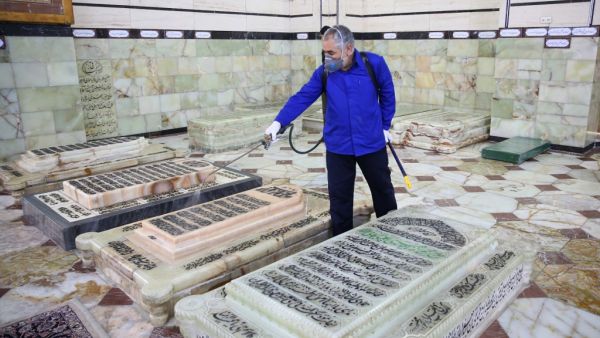 An Iranian sanitary worker disinfects Qom's Masumeh shrine on February 25, 2020 to prevent the spread of the coronavirus which reached Iran, where there were concerns the situation might be worse than officially acknowledged. AFP