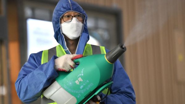 A worker wearing protective gear sprays disinfectant as part of preventive measures against the spread of the COVID-19 coronavirus, at a railway station in Daegu on February 26, 2020. An American soldier stationed in South Korea has tested positive for the COVID-19 coronavirus, commanders said on February 26, as the country's case total jumped again. Meanwhile, South Korean authorities reported 169 new infections, taking the overall national tally to 1,146, by far the largest outside China. Jung Yeon-je / A