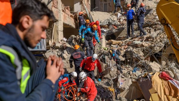 Rescue workers work amid the rubble of a building after an earthquake in Elazıg, eastern Turkey, on Saturday. Photo: Bulent Kilic/AFP via Getty Images