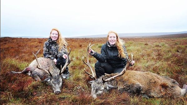 Rikke (left) and Trine (right) Jacobsen, from Ry in Denmark, post pictures of themselves smiling as they stand over the animal corpses. They are pictured with stags in the Scottish Highlands. (Daily Mail)
