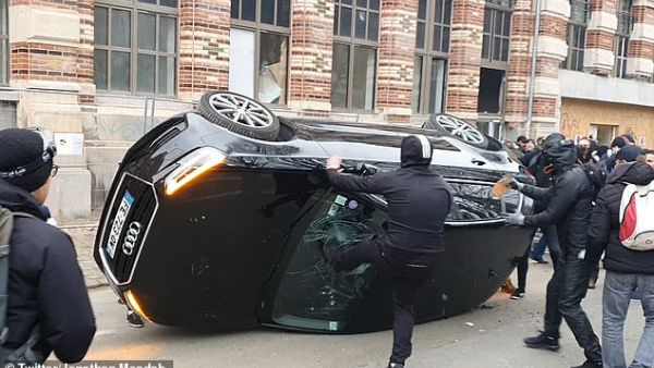 Anti-Macron rioters were caught on camera flipping an Audi on to its roof in Lille before smashing the windscreen. (Twitter)