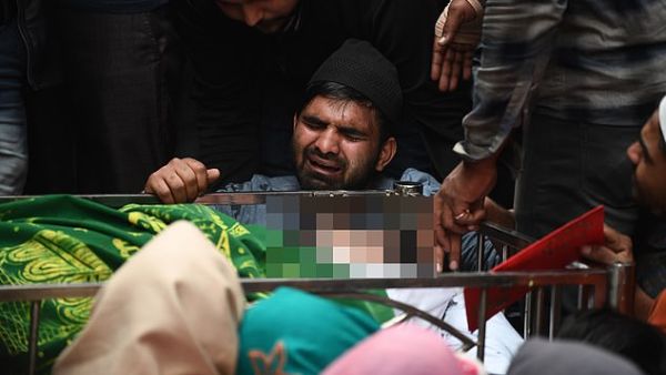 The brother (centre) of Mohammad MudAsir, 31, who died in the recent sectarian riots in India's capital over Prime Minister Narendra Modi's citizenship law, reacts during his brother's funeral in New Delhi today. AFP