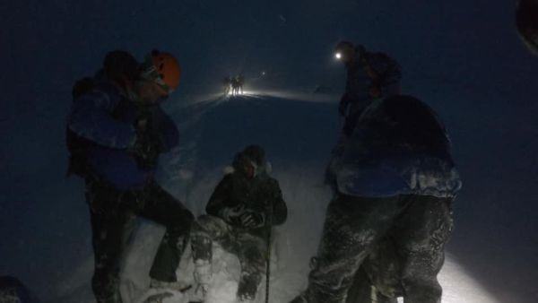 The 'stupid' quartet (one walker pictured sitting down) became trapped near the 4,411ft-high summit after embarking upon a walk up Ben Nevis during freezing 80mph winds (Twitter)