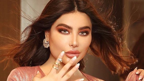 Angie posed along with a giant red teddy bear in a sexual way (source: @singerangiekhoury Instagram)