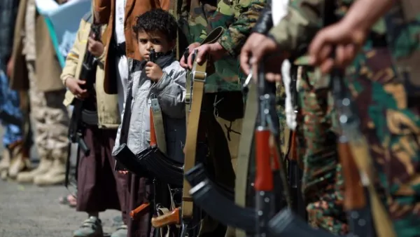 Yemeni children hold automatic rifles as they join grown up relatives in a tribal gathering organised by the Shiite Huthi movement (Picture: MOHAMMED HUWAIS/AFP/Getty Images)