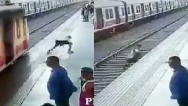 The boy ran across the tracks and narrowly missed the train in Thane, on the outskirts of Mumbai, India. He was a second in front of the train. (Video Screenshots)