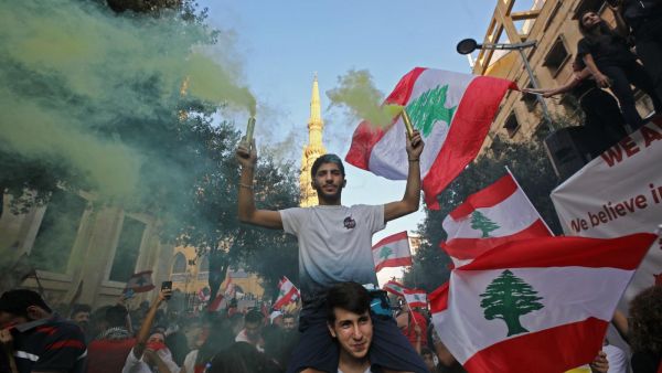 Lebanese protesters demand better living conditions and the removal of a cast of politicians who have monopolised power and influence for decades at Riad al-Solh Square in Beirut (AFP)
