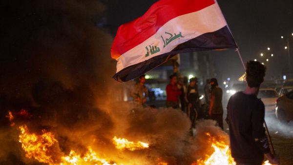 Anti-government demonstrators block a street with burning tyres during a protest in the southern Iraqi city of Basra on February 25, 2020. Hussein FALEH / AFP