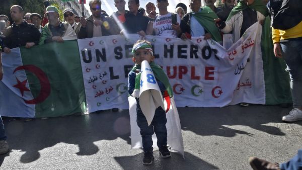 Algerian demonstrators wave the national flag during a demonstration in the capital Algiers, on February 28, 2020. Mass protests erupted in Algeria a year ago last Saturday, in response to President Abdelaziz Bouteflika announcing he intended to run for a fifth term after 20 years in power -- despite being debilitated by a 2013 stroke. RYAD KRAMDI / AFP