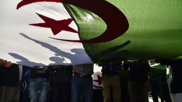 Algerian demonstrators wave the national flag during a demonstration in the capital Algiers, on February 28, 2020. Mass protests erupted in Algeria a year ago last Saturday, in response to President Abdelaziz Bouteflika announcing he intended to run for a fifth term after 20 years in power -- despite being debilitated by a 2013 stroke. RYAD KRAMDI / AFP