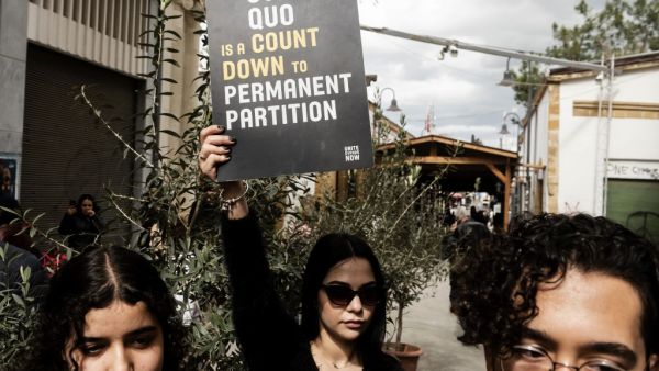 Cypriot demonstrators gather in the the United Nations Buffer Zone during a protest against the closure of checkpoints at the Ledra Street checkpoint in the divided capital of Nicosia on February 29, 2020. Cyprus announced the temporary closure of half of the crossing points across the divided island's ceasefire line in an effort to prevent a coronavirus outbreak. Four of the eight checkpoints will be shut for seven days "for more effective control over the entry points," said health minister Constantinos I
