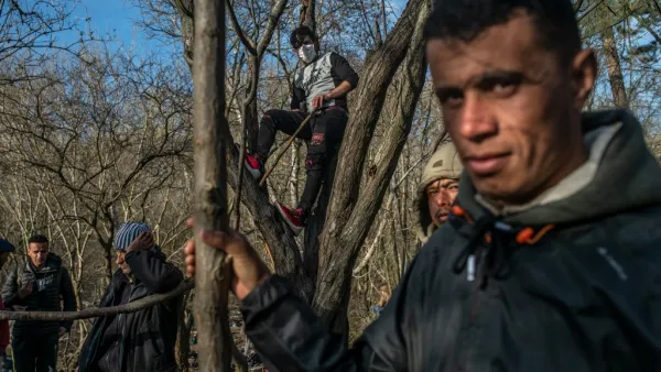 Migrants wait at the buffer zone in front of the Pazarkule border crossing to Greece, in Edirne on March 3, 2020. Migrants and refugees hoping to enter Greece from Turkey appeared to be fanning out across a broader swathe of the roughly 200-kilometer-long land border on March 3, 2020, maintaining pressure on the frontier after Ankara declared its borders with the European Union open. BULENT KILIC / AFP