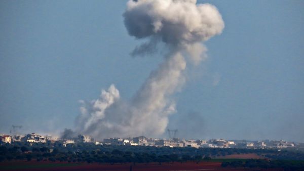 A picture taken from Binnish shows smoke billowing above buildings during pro-regime forces air strikes on rebel-held areas surrounding the regime-controlled town of Saraqeb, in the northwestern Idlib province on March 4, 2020. Muhammad HAJ KADOUR / AFP