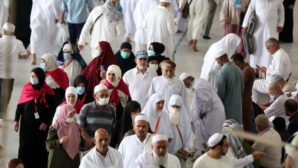 Worshippers, some of them wearing protective masks, walk around Mecca's Grand Mosque on March 6, 2020, a day after Saudi authorities emptied Islam's holiest site for sterilisation over fears of the new coronavirus COVID-19, an unprecedented move after the kingdom suspended the year-round umrah pilgrimage. Abdel Ghani BASHIR / AFP