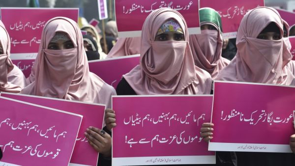 Supporters of the Pakistani Islamic political party Jamaat-e-Islami (JI) hold placards as they march during a rally to mark the International Women's Day in Lahore on March 8, 2020. Demonstrators were gathering for rallies across Pakistan on March 8 to mark International Women's Day in an ultra-conservative society where women are still put to death under ancient "honour" codes. ARIF ALI / AFP