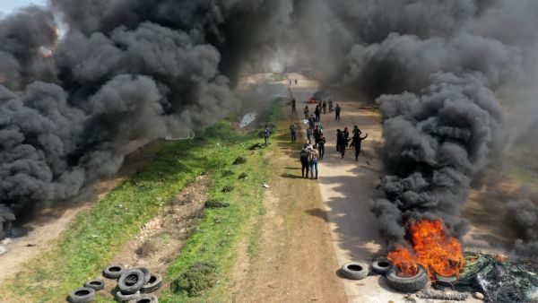 Syrians protest and burn tyres in an attempt to block traffic on the M4 highway, which links the northern Syrian provinces of Aleppo and Latakia, before incoming joint Turkish and Russian military patrols (as per an earlier agreed upon ceasefire deal) in the village of al-Nayrab, about 14 kilometres southeast of the city of Idlib and seven kilometres west of Saraqib in northwestern Syria on March 15, 2020. Russian President Vladimir Putin and his Turkish counterpart Recep Tayyip Erdogan reached a deal on Ma