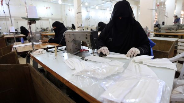 Yemeni women make face masks at a textile factory in the capital Sanaa on March 16, 2020. More than a decade after it shut down, 20 women have brought back to life Yemen's oldest industrial factory to manufacture what could save many lives amid a global pandemic: masks. Mohammed HUWAIS / AFP
