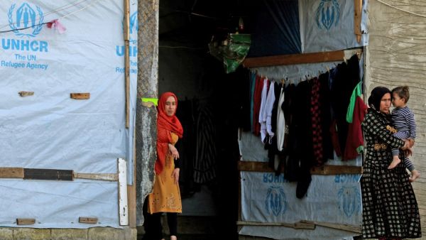 Syrian refugees are picture in a building under construction they have been using as a shelter in the city of Sidon in southern Lebanon, on March 17, 2020 amidst the coronavirus COVID-19 epidemic. AFP/File