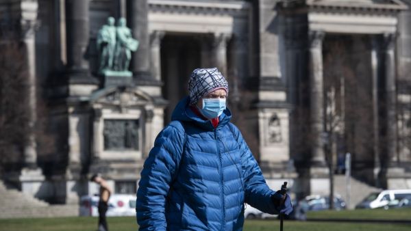 A man wearing a surgical mask walks past Berlin's Cathedral (Berliner Dom) in Berlin on March 17, 2020. John MACDOUGALL / AFP
