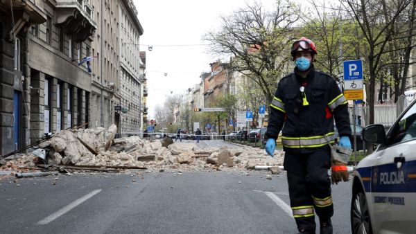 A Croatian fireman walks past rubbles laying on the ground, in a street of downtown Zagreb, on March 22, 2020, after an earthquake hit the country at 06:00 am (0500 GMT). A 5.3-magnitude earthquake shook the Croatian capital of Zagreb on March 22, 2020, damaging buildings and cutting electricity in a number of neighbourhoods. Damir SENCAR / AFP