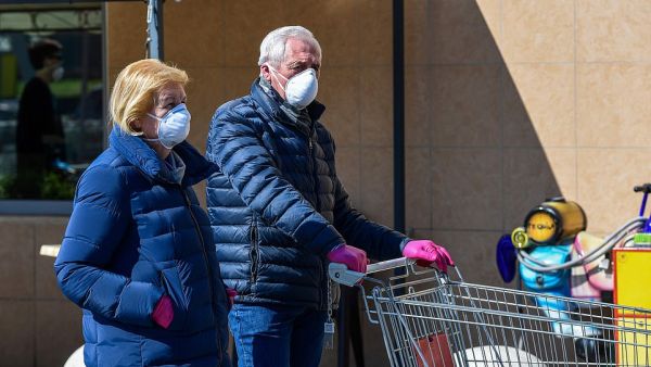 Residents of Milan sporting protective masks during a shopping trip last week after the country implemented a nationwide lockdown. AFP