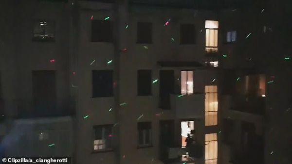 Locals in Rome leaned out of their windows to shine the lights onto the apartments of their neighbours as part of a communal disco on Sunday evening, on the sixth night of lockdown. (Video Screenshot)