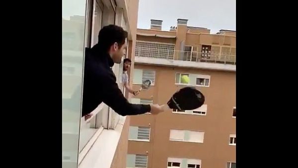 High-level stunts: These men, from an unknown location, played tennis between windows. (Twitter)