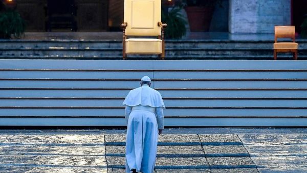 Pope Francis walked alone up the stairs to St Peter's Basilica to deliver the extraordinary 'Urbi et Orbi' blessing (AFP)