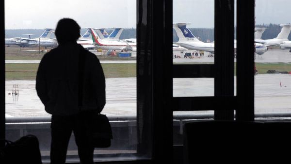 A man looks at planes at the international airport outside Minsk on April 17, 2010 (AFP Photo/Viktor Drachev)