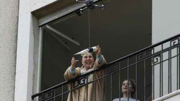 Under lockdown over coronavirus, a drone buzzed towards a balcony on Saturday to deliver a red rose to a mother grinning in surprise. Three students have come up with a new service to celebrate the occasion without social restriction (Twitter)