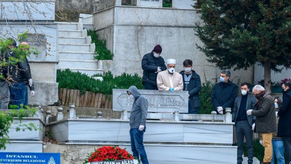 People with protective face mask attend the funeral of Istanbul University Faculty of Medicine's doctor Cemil Tascioglu, the country's first medical professional to pass away from the novel coronavirus (COVID-19) disease, on April 2, 2020, in Istanbul.