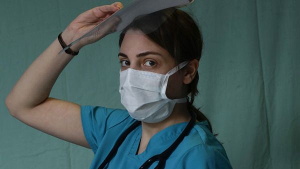 Sarah Eid, a 27-year-old internal medicine resident physician treating COVID-19 coronavirus patients, poses for a picture at Saint George Hospital University Medical Centre in the eastern Ashrafieh district of the Lebanese capital Beirut on April 2, 2020. JOSEPH EID / AFP