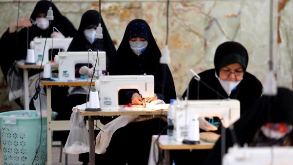 Iranian women, members of paramilitary organisation Basij, make face masks and other protective items at a mosque in the capital Tehran, amid the novel coronavirus pandemic crisis on April 5, 2020. The spread of the virus in Iran has slowed for the fifth day in a row, according to official figures released today by the authorities, who also announced plans for a gradual resumption of certain economic activities starting on April 11. ATTA KENARE / AFP