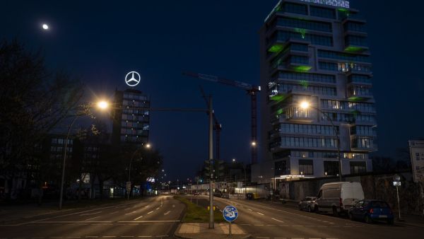 An electronic display board on top of a residential building overlooking the river Spree reads: "#stay at home" on April 6, 2020 in Berlin, amid a new coronavirus Covid-19 pandemic. John MACDOUGALL / AFP / POOL