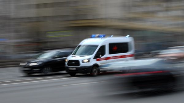 An ambulance drives along a street in Moscow on April 10, 2020. Moscow's hospitals and ambulance service are working at peak capacity after a sharp rise in those hospitalised with serious coronavirus complications, a senior city official said on April 10. Kirill KUDRYAVTSEV / AFP