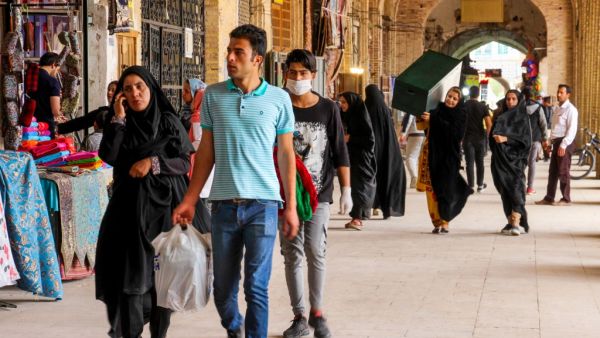 Iranians, some wearing personal protective equipment, walk past shops in the southeastern city of Kerman on April 11, 2020, amid the coronavirus (COVID-19) pandemic. Iran reported 125 new deaths from the novel coronavirus, raising the overall toll in the Middle East's worst-hit country to 4,357. Health ministry spokesman Kianoush Jahanpour told a news conference that 1,837 new infections had been confirmed in the past 24 hours, taking the total to 70,029. ISNA / AFP