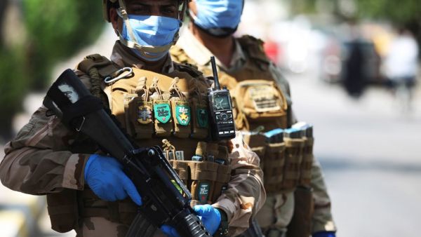 Iraqi soldiers stand at a checkpoint in the Adhamiya district of Baghdad on April 13, 2020 as Iraq imposed a curfew during the coronavirus COVID-19 pandemic. AHMAD AL-RUBAYE / AFP