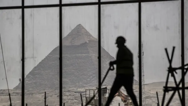 A picture taken on April 13, 2020, shows a view of the Great pyramid of Khafre (Chephren) seen through the scaffolding on the Grand Egyptian Museum (GEM), which is currently under construction, in Giza on the southwestern outskirts of the capital Cairo. Khaled DESOUKI / AFP