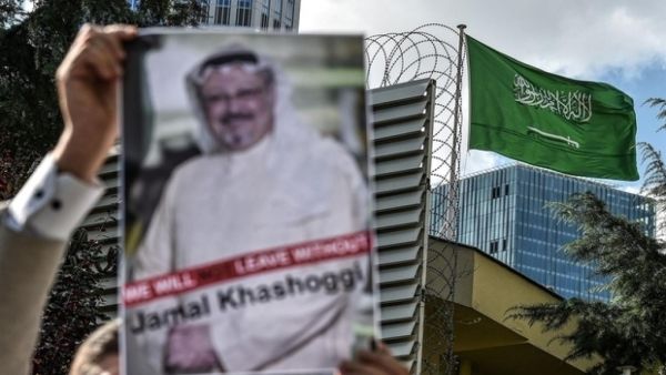 A demonstrator outside the Saudi consulate in Istanbul holds up an image of Jamal Khashoggi (AFP)