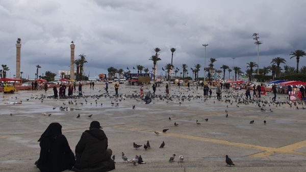 Libyans sit at Martyrs square in the capital Tripoli on March 10, 2020. According to Libyan authorities, not a single case of coronavirus so far has been recorded in the country which faces Italy across the Mediterranean. Libya's centre for disease control, the Tripoli-based CNLM, said it has readied measures to be adopted if the virus infiltrates the country. "The virus has circled Libya from all sides. Our neighbours have confirmed cases so we must monitor the cross-border threat," CNLM president Badreddi
