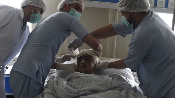 In this photo taken on March 16, 2020, wounded Afghan policeman Mujib Rahman receives treatment at the Afghan National Police Hospital in Kabul. Since the Taliban were ousted in a US-led invasion in 2001, about 37,000 police officers have been killed by the hardline Islamists and the Afghan National Police (ANP) remain the target of at least 70 percent of insurgent assaults, officials say. WAKIL KOHSAR / AFP