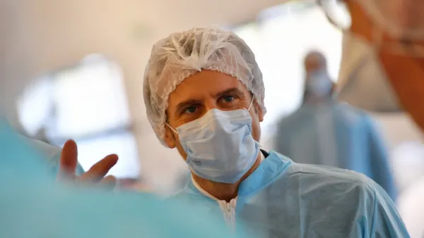 French President Emmanuel Macron wearing protective suit and face mask visits the Kolmi-Hopen protective face masks factory in Saint-Barthelemy-d'Anjou near Angers, central France, on March 31, 2020 amid a new coronavirus (COVID-19) pandemic. LOIC VENANCE / POOL / AFP
