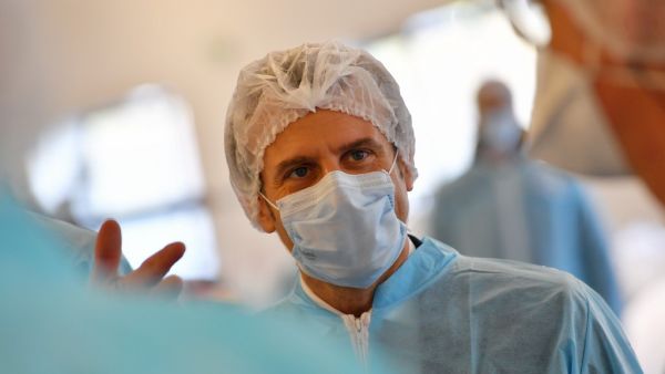 French President Emmanuel Macron wearing protective suit and face mask visits the Kolmi-Hopen protective face masks factory in Saint-Barthelemy-d'Anjou near Angers, central France, on March 31, 2020 amid a new coronavirus (COVID-19) pandemic. LOIC VENANCE / POOL / AFP