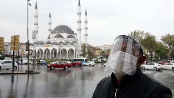 A man wearing a face-shield for protective measures crosses the streets as the spread of the COVID-19, the novel coronavirus continues in Ankara, on April 30, 2020. Adem ALTAN / AFP