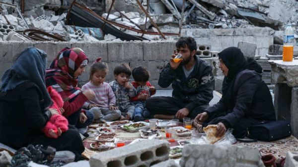 This picture taken on May 4, 2020 during the Muslim holy fasting month of Ramadan shows members of the displaced Syrian family of Tareq Abu Ziad, from the town of Ariha in the southern countryside of the Idlib province. AAREF WATAD / AFP
