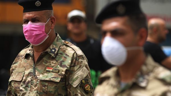 Members of the Iraqi security forces wearing protective masks keep watch at Tahrir Square in central Baghdad on May 5, 2020 during of the Muslim holy month of Ramadan after authorities eased up the lockdown measures that they had imposed in a bid to slow the spread of the novel coronavirus Covid-19. AHMAD AL-RUBAYE / AFP