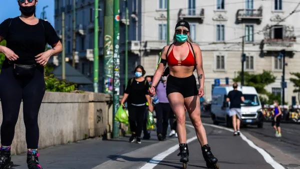 Women wearing a face mask roller skate along the Navigli canals in Milan on May 8, 2020 during the country's lockdown aimed at curbing the spread of the COVID-19 infection, caused by the novel coronavirus. Miguel MEDINA / AFP