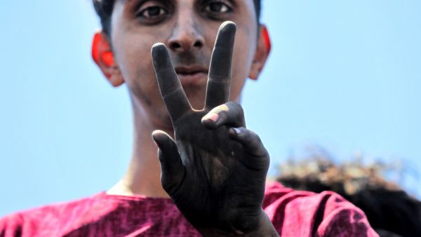An Iraqi protester gestures as he stands on the Al-Jumhuriyah bridge in the capital Baghdad on May 11, 2020, during an anti-government demonstration. Modest anti-government rallies resumed in some Iraqi cities Sunday, clashing with security forces and ending months of relative calm just days after Prime Minister Mustafa Kadhemi's government came to power. The protests first erupted in Baghdad and Shiite-majority southern cities in October, demanding an end to corruption and unemployment and an overhaul of t