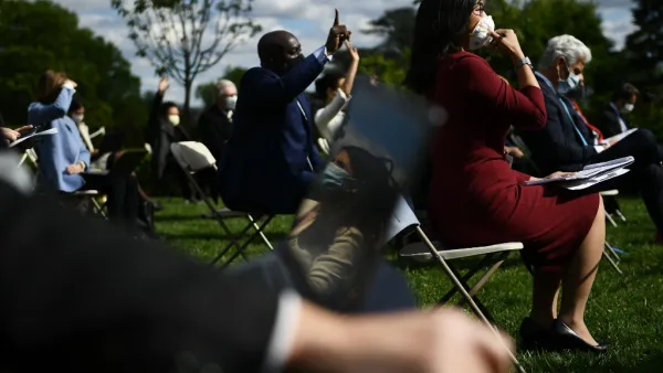 Reporters wearing masks ask questions as US President Donald Trump speaks during a news conference on the novel coronavirus, COVID-19, in the Rose Garden of the White House in Washington, DC on May 11, 2020. Brendan Smialowski / AFP