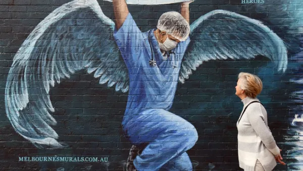 A woman looks at a mural of a health worker with wings holding a globe on International Nurses Day in Melbourne on May 12, 2020. As frontline hospital staff are constantly facing the risks from the COVID-19 coronavirus outbreak, the world is marking International Nurses Day, celebrated around the world every May 12, the anniversary of Florence Nightingale's birth. William WEST / AFP